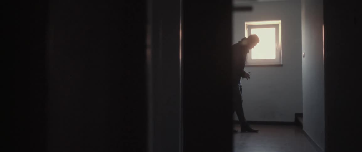 A man leans against the wall