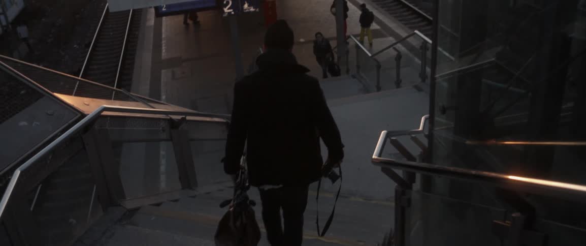 A man walks down steps near a station