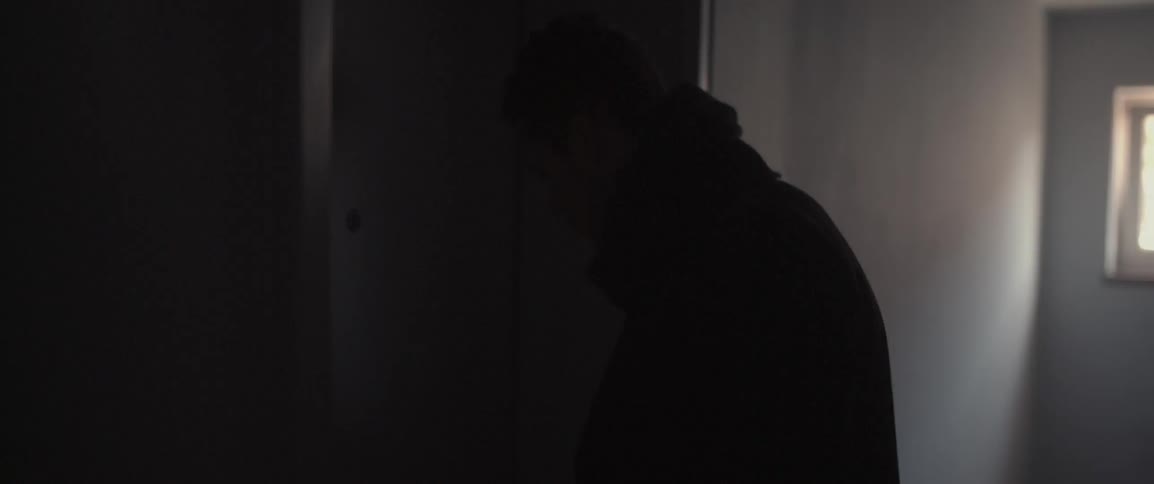 A man opens the door to an apartment