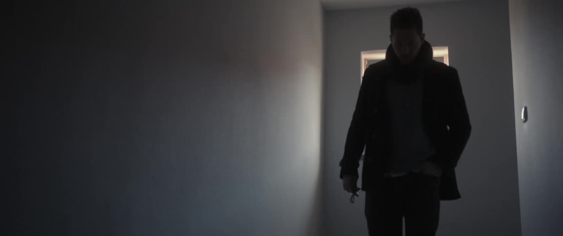 A man walks from a window