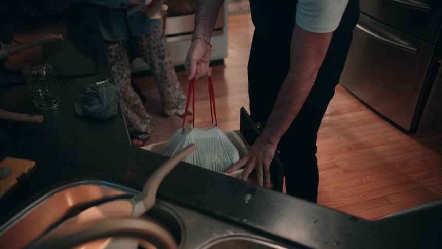 Two people taking out the trash