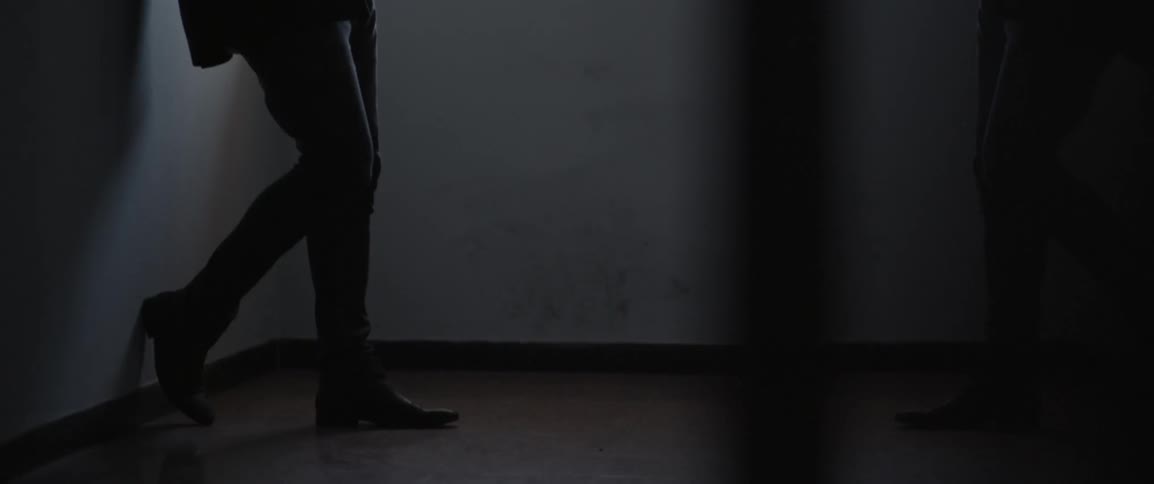 A person is standing in a dark hall