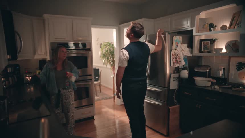 Couple cleaning the kitchen together