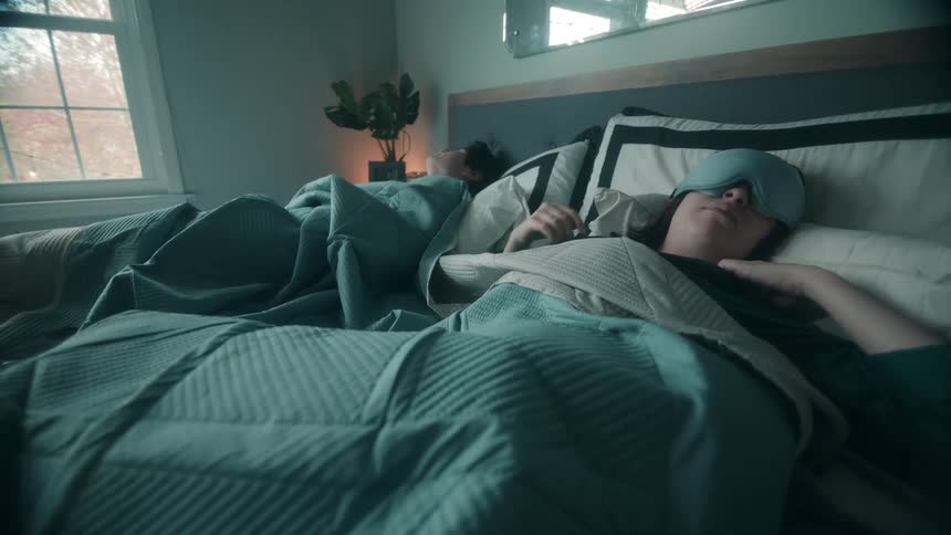 The man and woman wake and take off their blindfolds