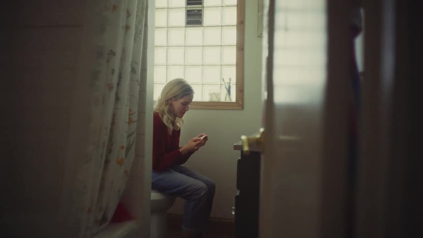 A woman reading a pregnancy test