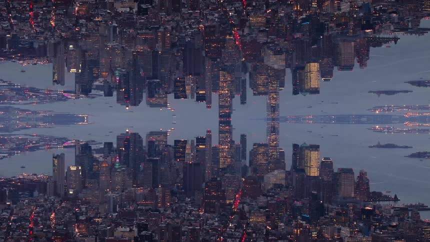 A vertically mirrored symmetrical view of an illuminated city skyline at twilight