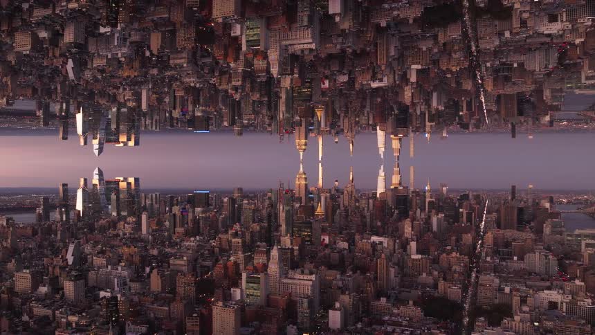 A mirrored view of a city landscape at dusk