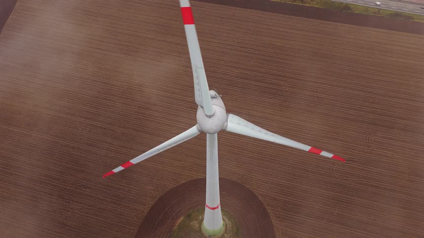 Aerial view of a wind turbine spinning