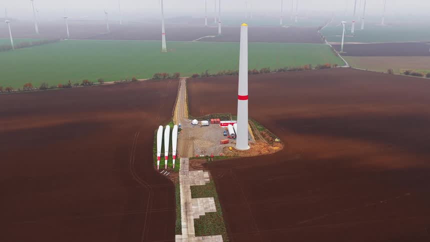 Aerial view of turbines on a wind farm on a foggy day