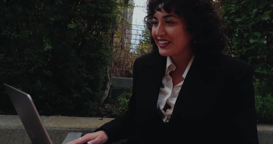 A woman using a laptop outdoors