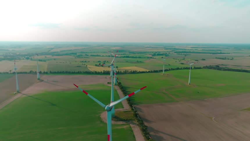 Aerial view of turbines spinning on a wind farm