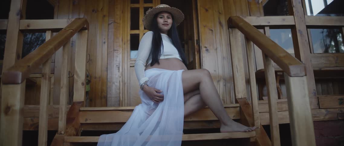 A portrait of a woman in a dress outdoors
