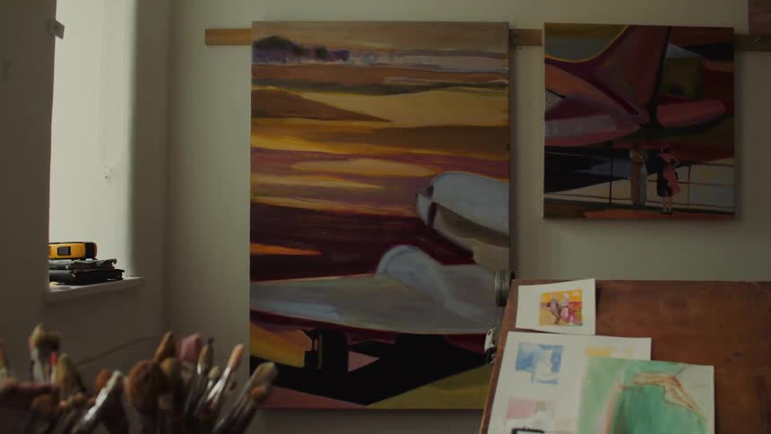 An art studio filled with framed paintings and drawings
