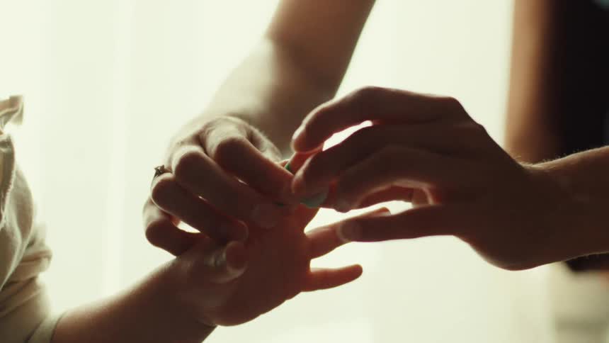 The mother puts a bandage on the girls finger