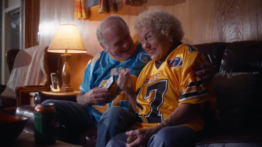 Couple wearing blaze team jerseys on the couch