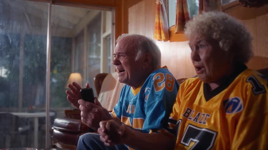 The sports fan become sad as they watch a game on the tv