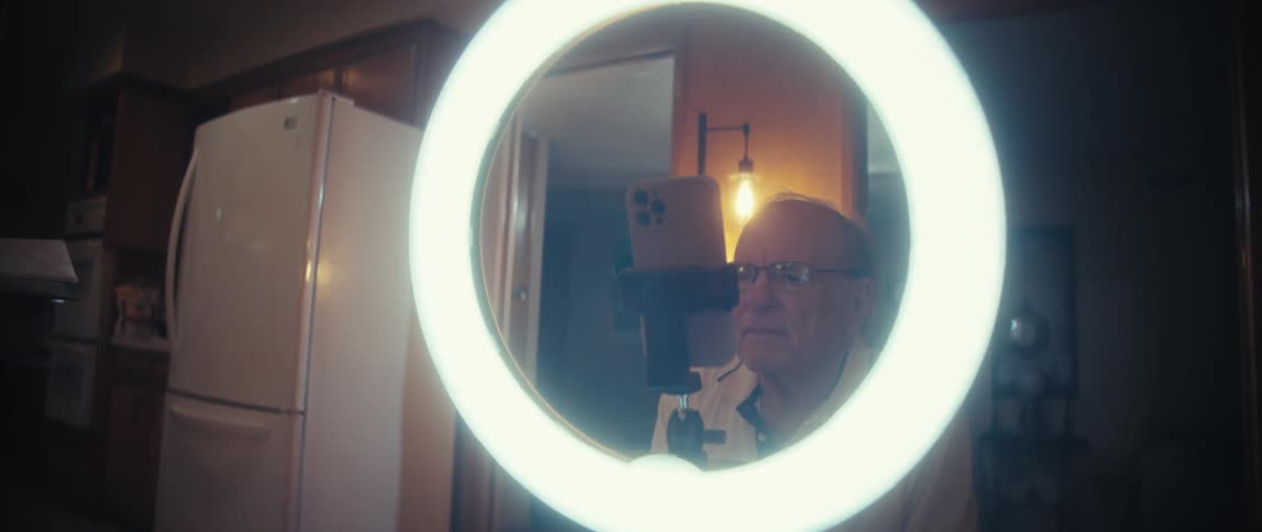 A man using a ring light and camera