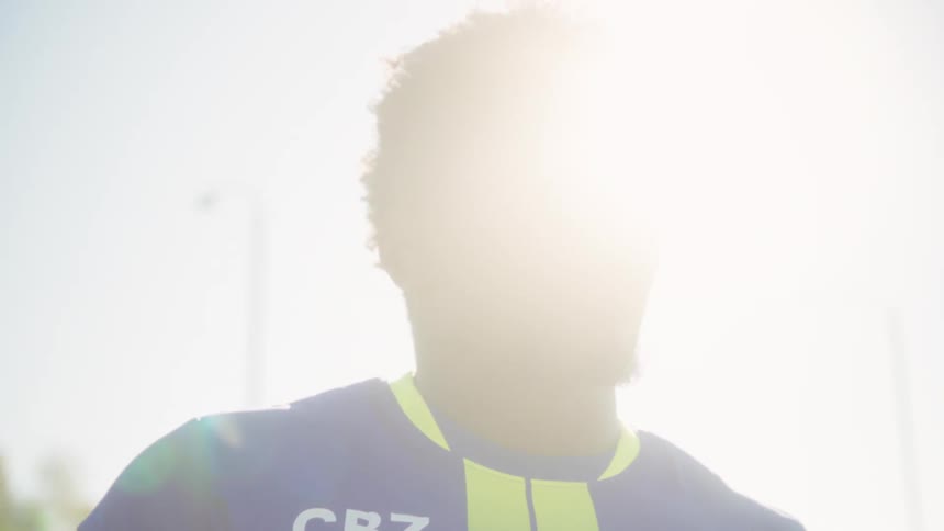 The sun is flaring behind the man