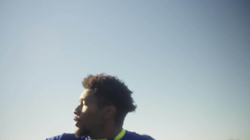 Man playing soccer and cheering happily