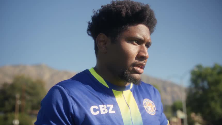Player with hand on head on sunny field
