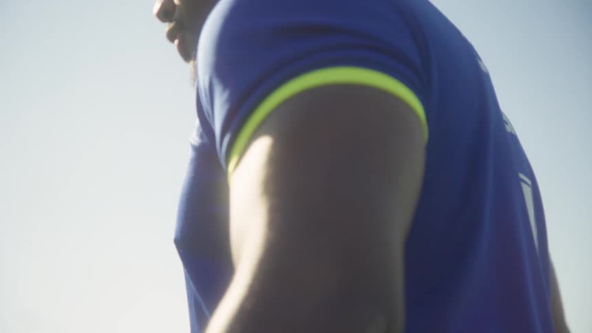 Soccer team captain trains in dribbling a soccer ball during the daytime