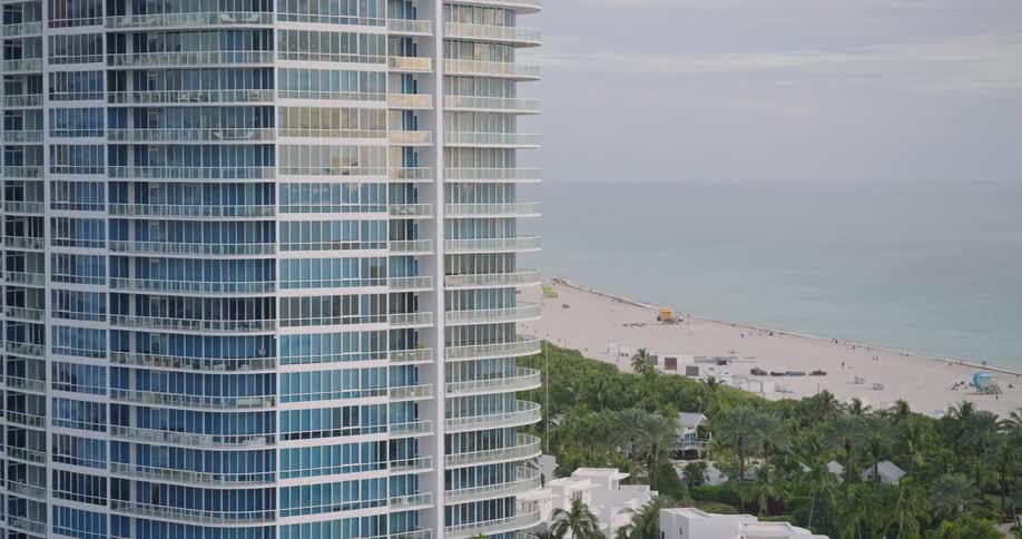 An aerial view of a beach with buildings next to it
