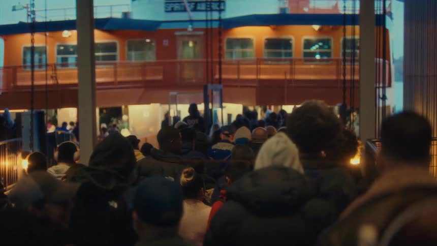 A crowd of people walking through large corridors in a building during daytime