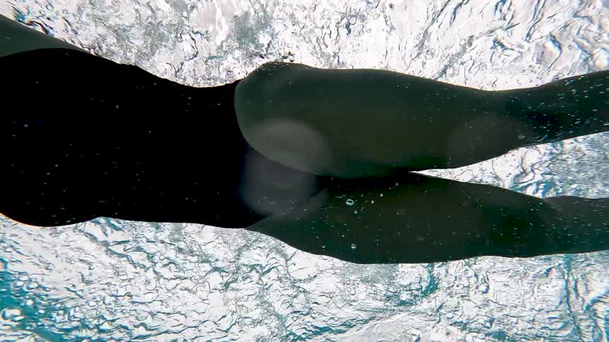 Swimmer seen underwater performing an arm stroke