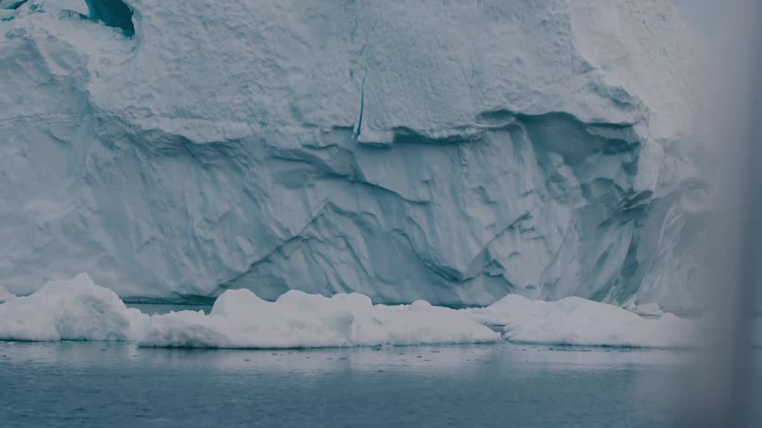 Floating ice blocks in front of a large glacial formation