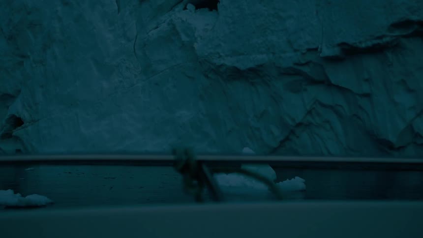 Boat navigating close to an ice wall