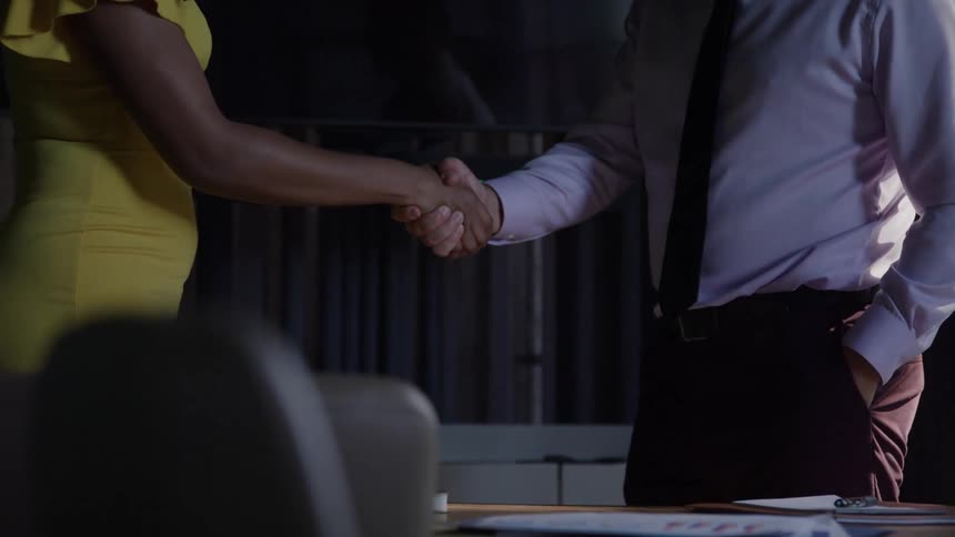 Man and woman shaking hands in the office