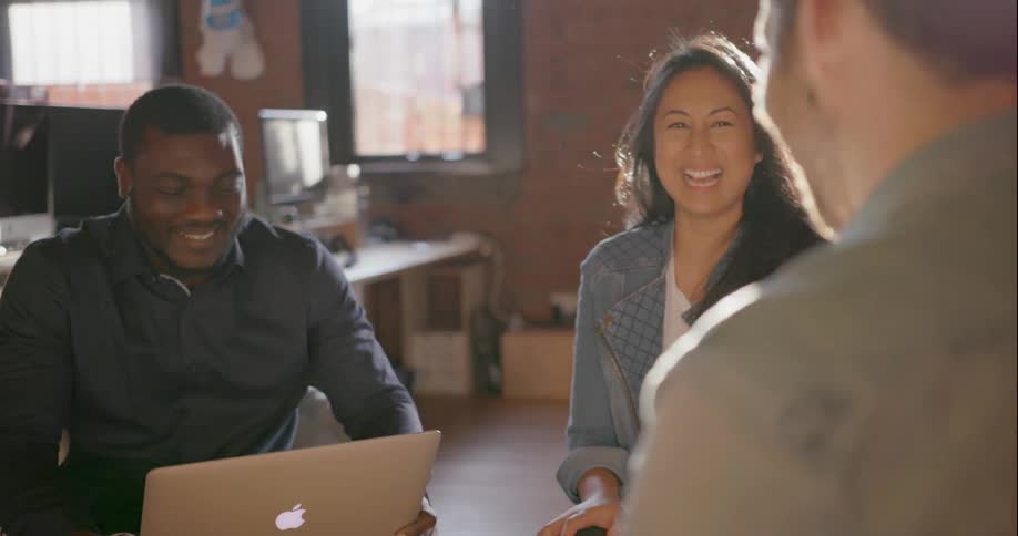 People sit and talk together in an office
