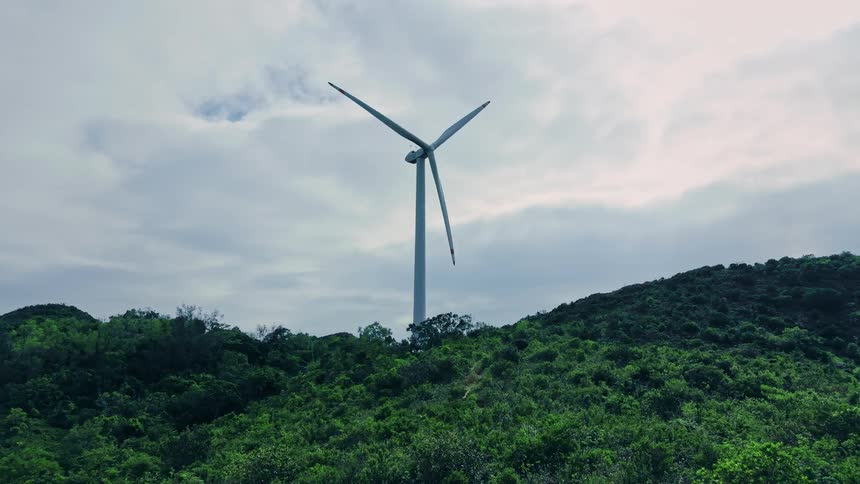 Wind turbine spinning on a mountain
