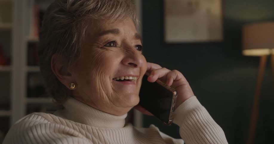 Woman laughs as she talks on her phone