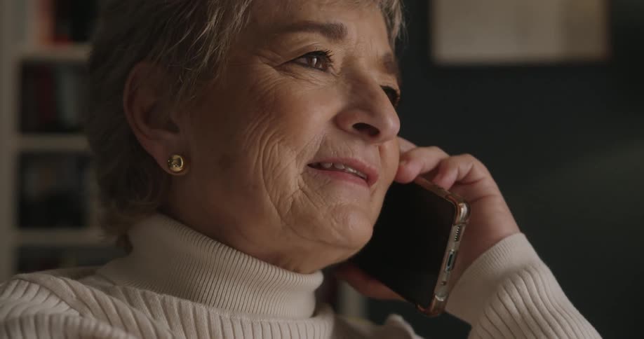 Woman smiles and laughs as she talks on her phone