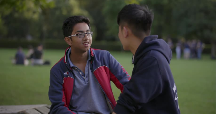 Two people talk in a park