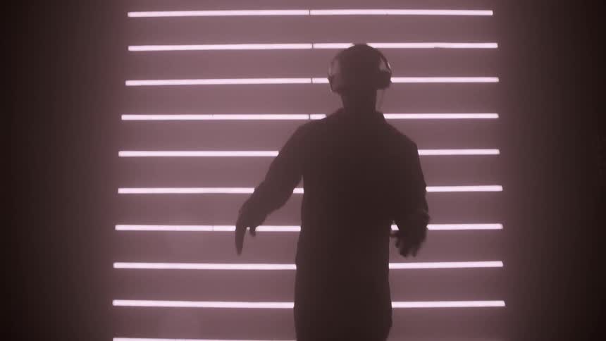 The man is break dancing in the dark