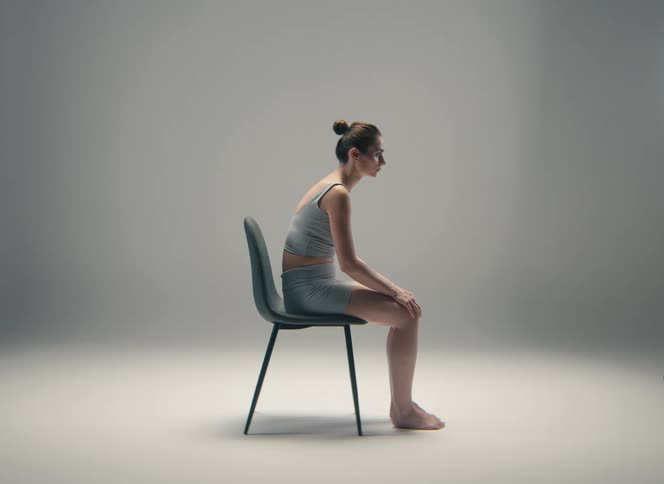 A woman sitting in a room in a chair
