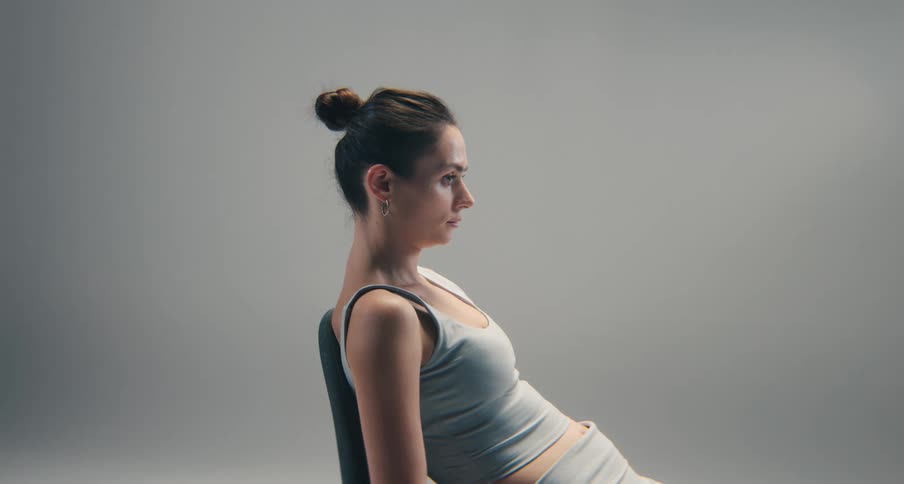 Woman reclining on a chair in a close sideprofile view