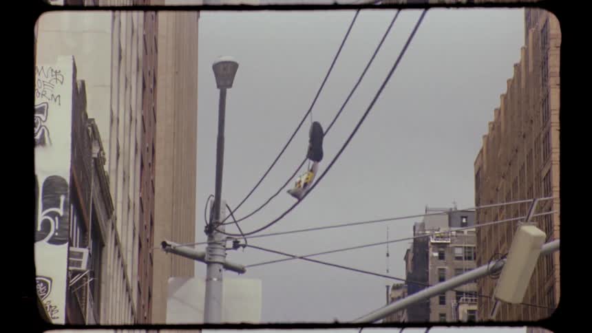 Tilted yellow traffic light and building faades seen from the corner of west 23rd street