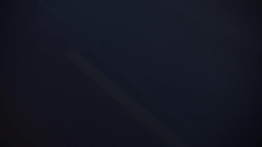 A slow abstract close view shows subtle lines of light gliding diagonally across a dark navy blue surface creating a smooth dynamic texture