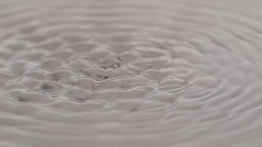 Water surface displaying small circular ripples
