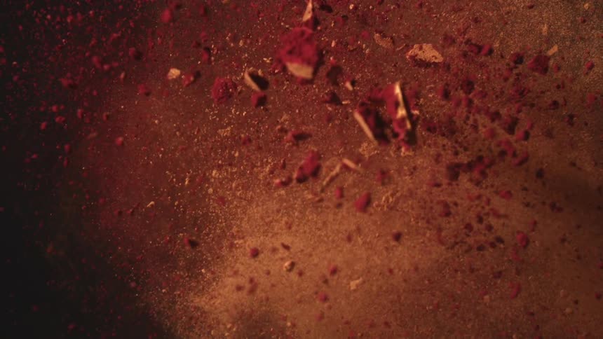 Reddish fragments and particles suspended in the air in closeup