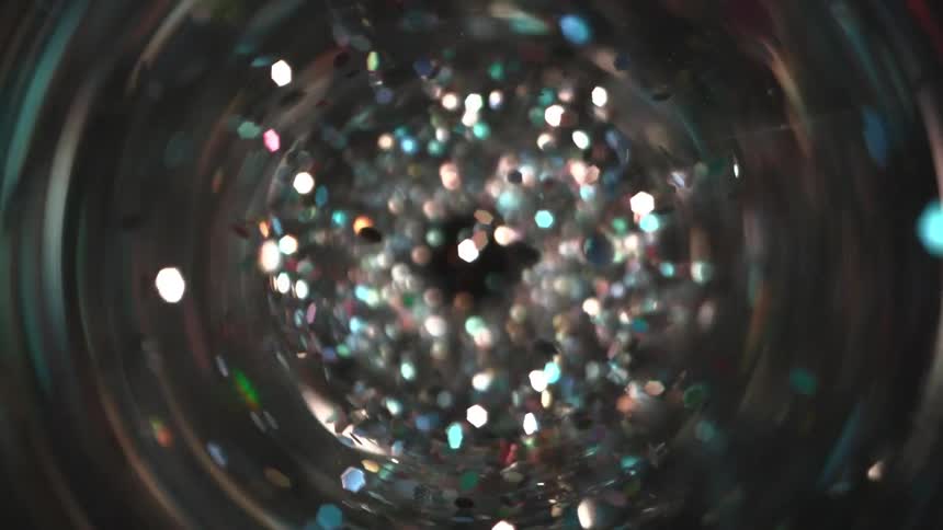 Multicolored light points reflected inside a cylinder