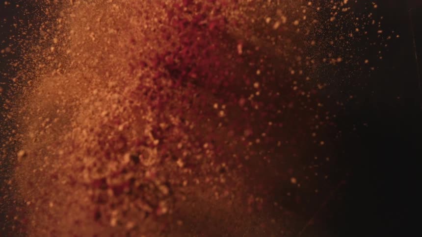 Fine orange dust particles suspended in the air in closeup