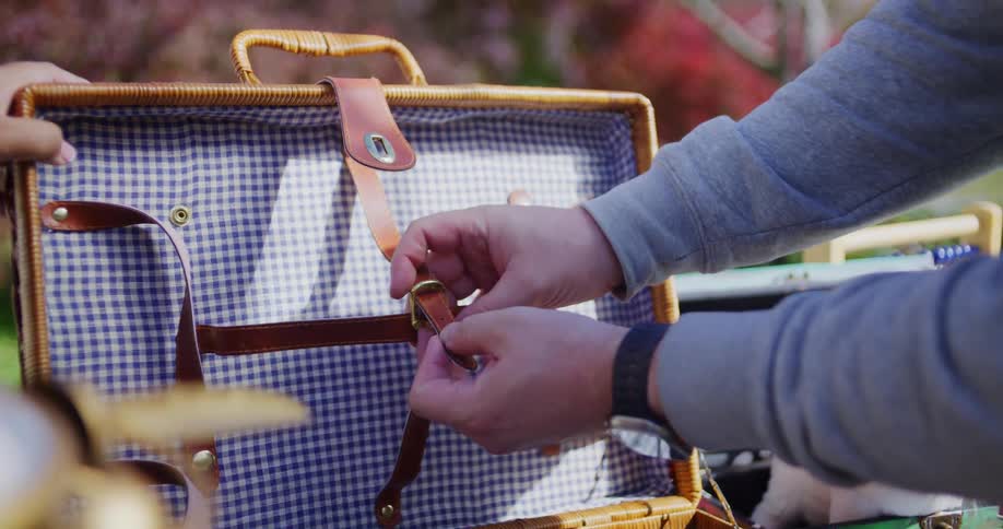 Two people looking at items in a suitcase