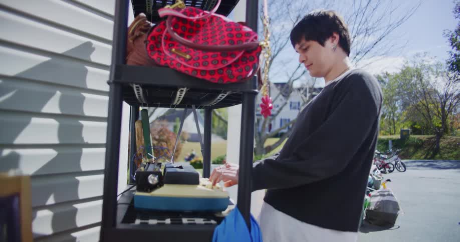 A man shopping for things at a yard sale