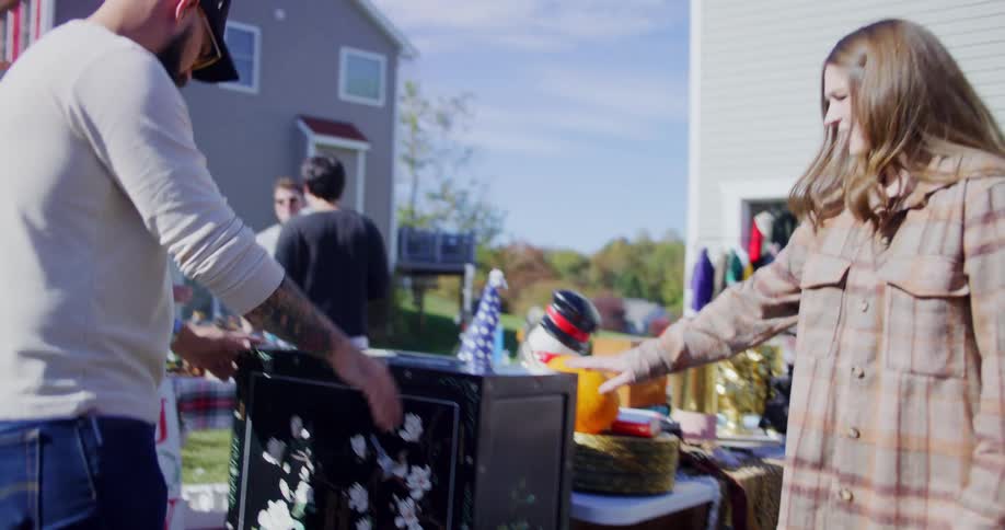 A group of people shopping at a yard sale