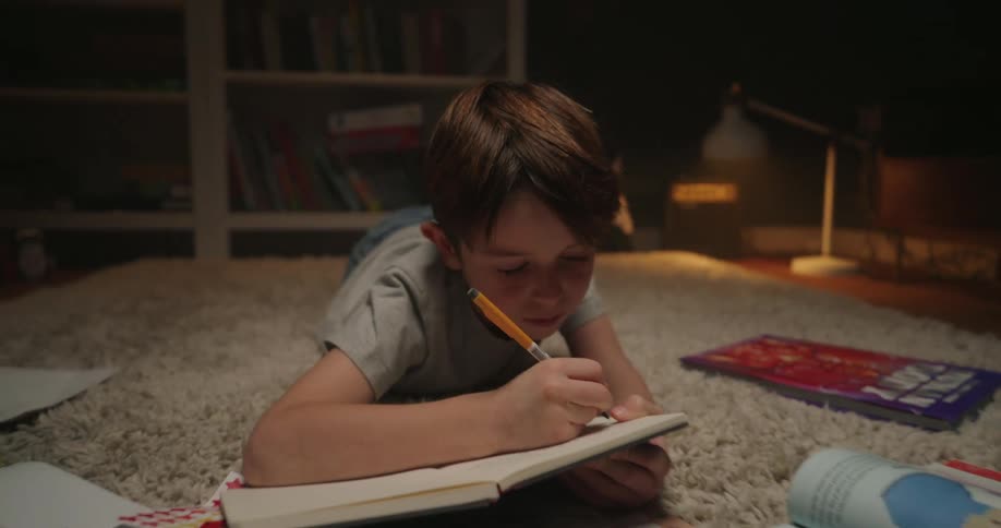 A child doing homework on the floor
