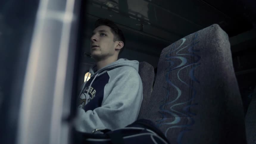 A man puts his bag on the bus seat